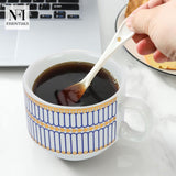 NFI essentials Set of 4 Ceramic Tea Cups With Stand Safe for the Microwave and Dishwasher Stackable Tea Cup  Printed Coffee Mugs for Gifting with Holder 150 ML - AYAHA ENTERPRISES PRIVATE LIMITED