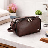 Brown leather toiletry bag with zip compartments for travel grooming essentials